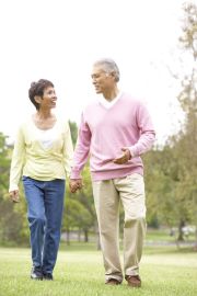 Senior Couple Walking In Park