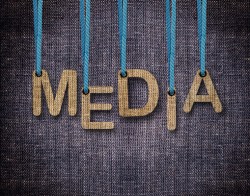 Media Letters hanging strings with blue sackcloth background.