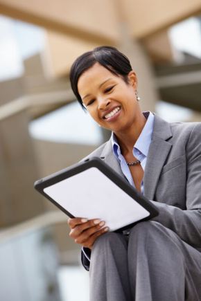 Businesswoman using tablet outdoors